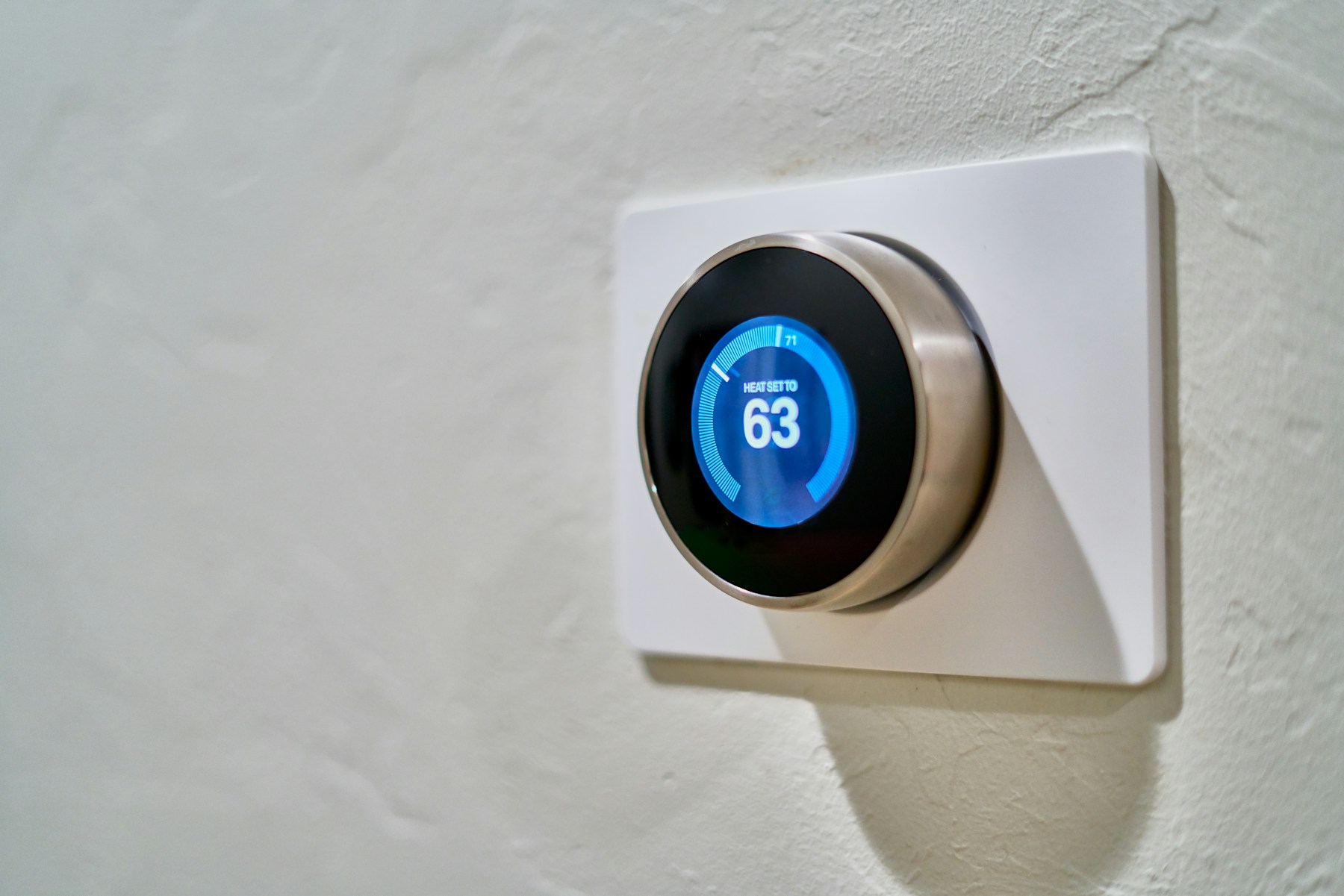 Smart thermostat mounted on a wall