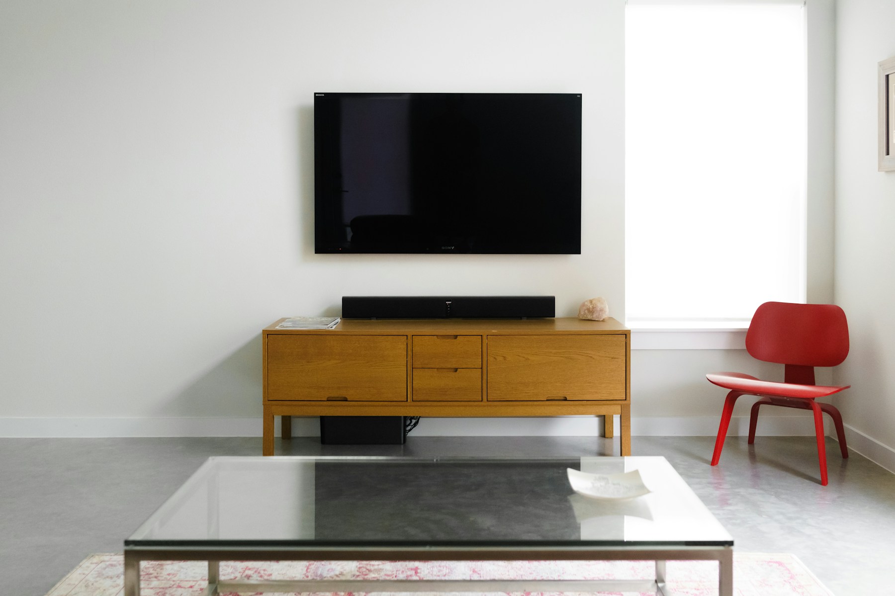 Wall-mounted television and soundbar in a living room